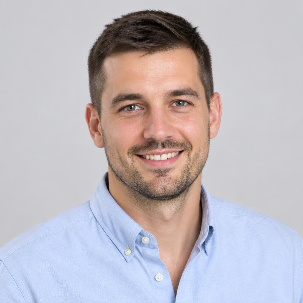 Studio portrait of a smiling man with short hair in a casual shirt
