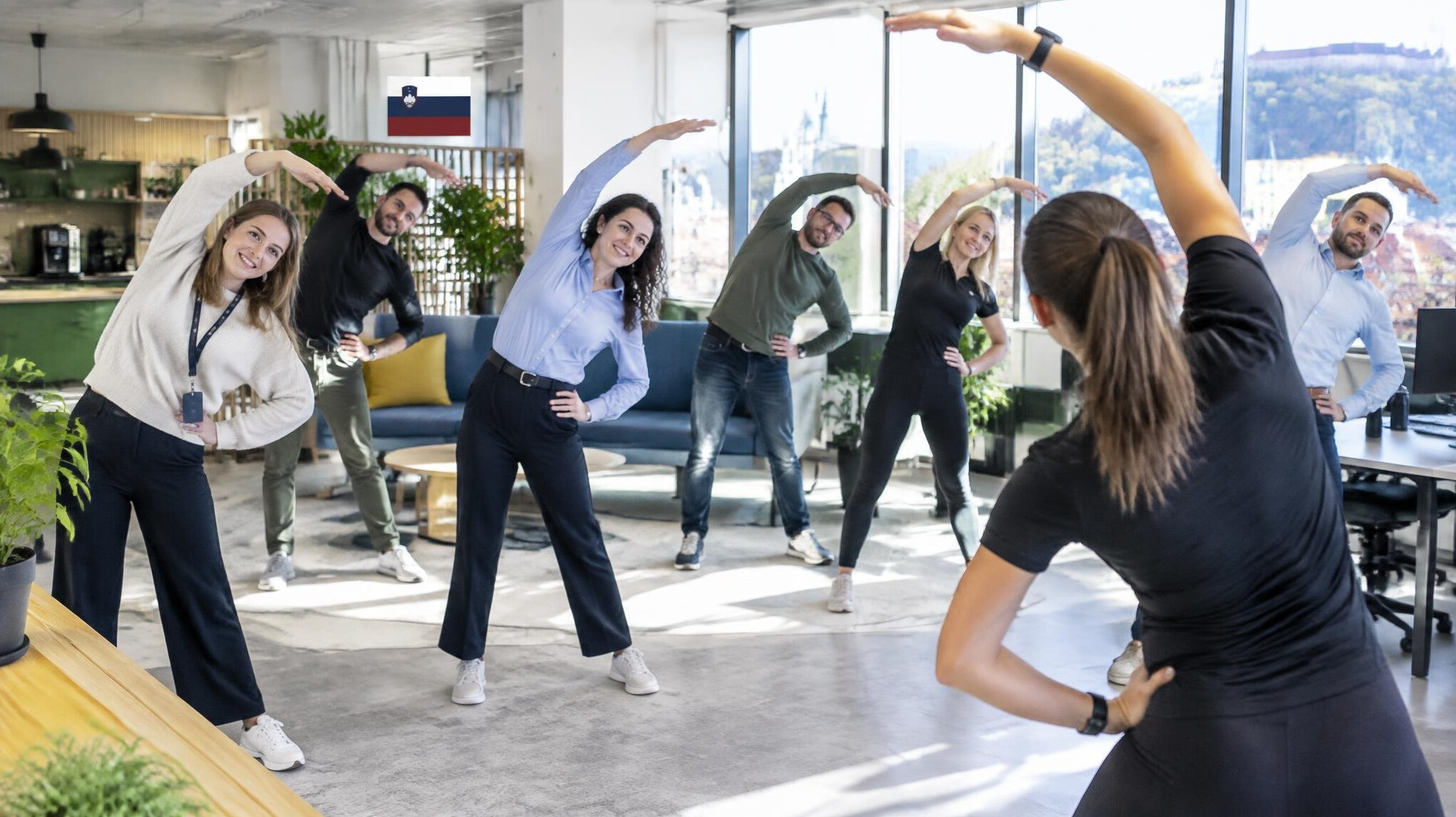 Group of employees doing a group fitness session in an office space
